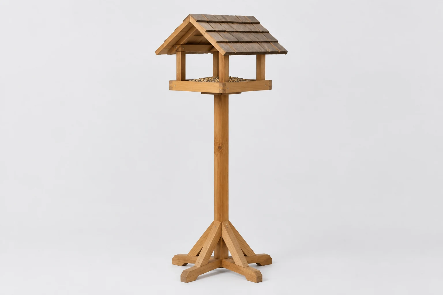 Wooden bird table with a pitched roof